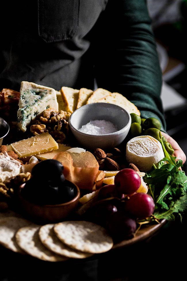 holding a cheese platter